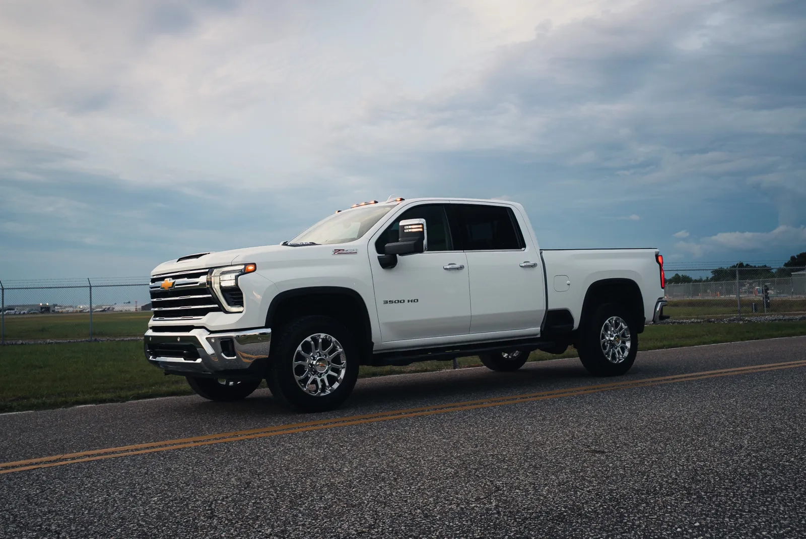 Finished white Chevy Silverado 3500HD, low front three-quarter