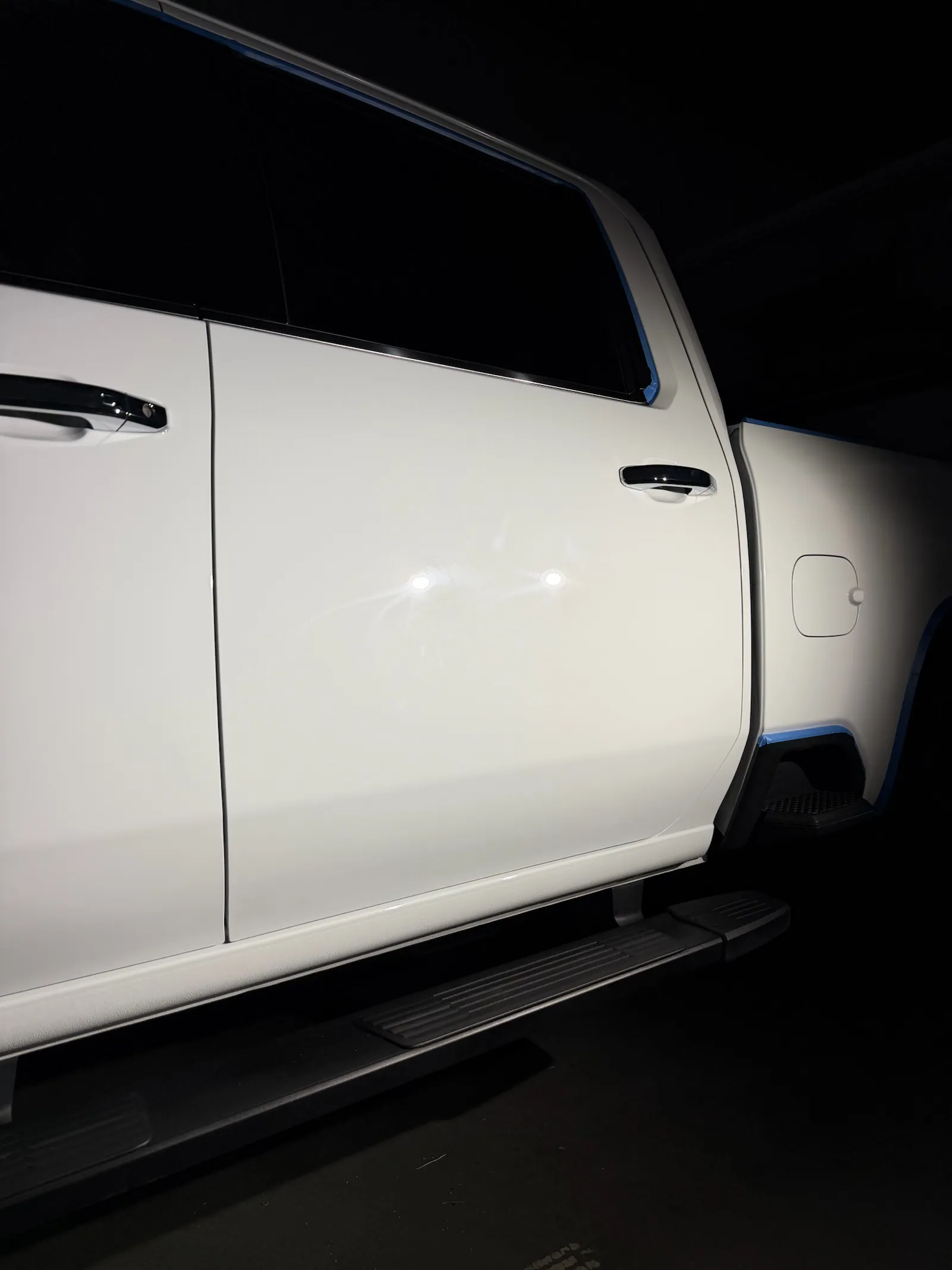 Before: side of a white Chevy Silverado 3500HD in the bay