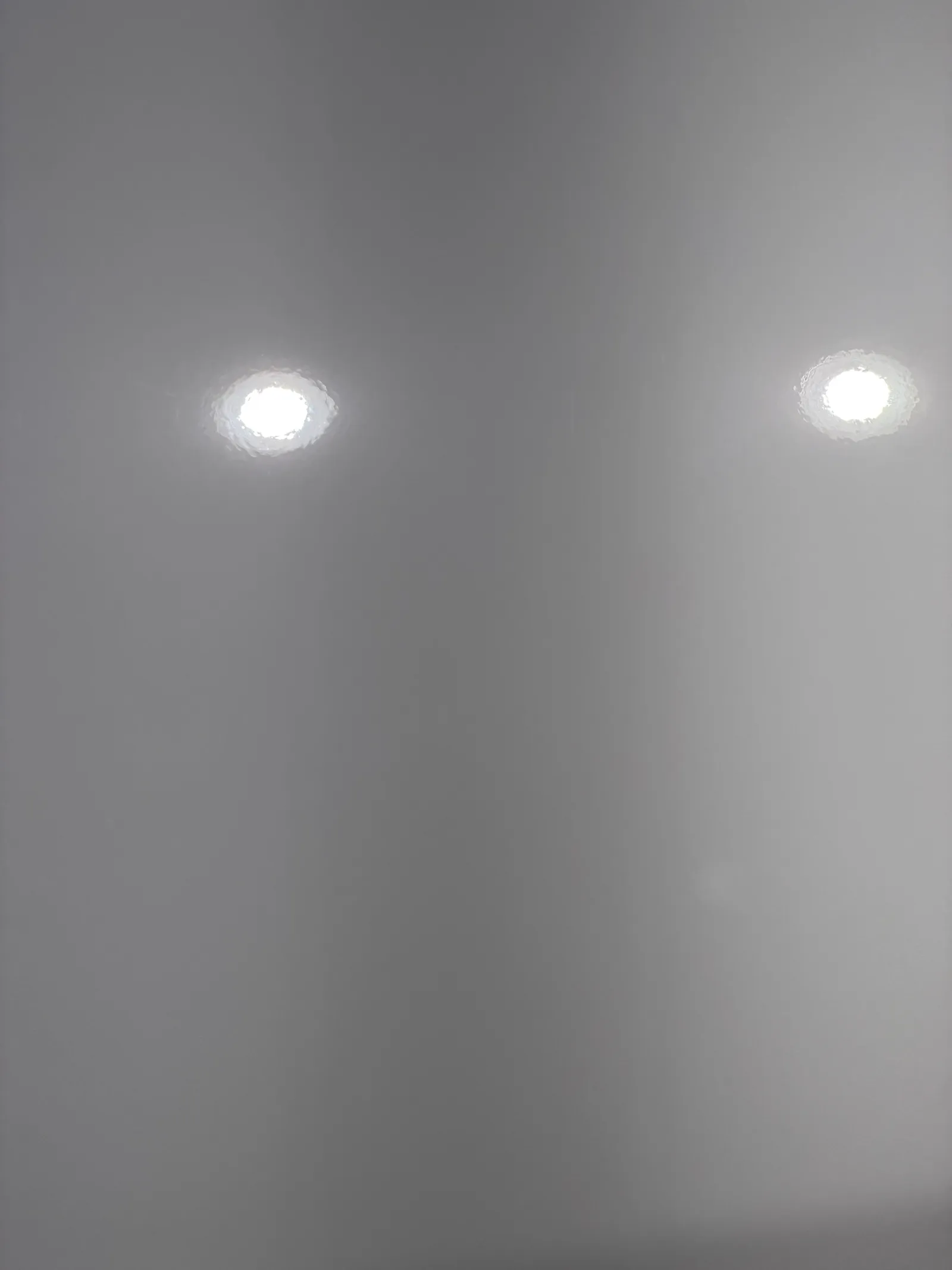 After: close-up of white Silverado door paint under inspection lights